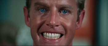 Movie still from “The Graduate” (1967), directed by Mike Nichols – A man's face with blue eyes; Extreme Close Up shot, Over the shoulder angle