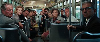 Movie still from “The Graduate” (1967), directed by Mike Nichols – A group of people riding on a bus; Wide shot, High angle