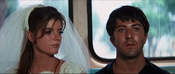 Movie still from “The Graduate” (1967), directed by Mike Nichols – A man and a woman sitting next to each other on a bus; Close Up shot, Low angle