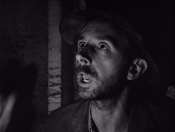 Movie still from “The Grapes of Wrath” (1940), directed by John Ford – A black and white photo of a man with a hat on; Close Up shot, Low angle