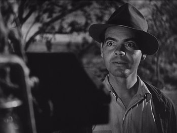 Movie still from “The Grapes of Wrath” (1940), directed by John Ford – A black and white photo of a man wearing a hat; Close Up shot, Low angle