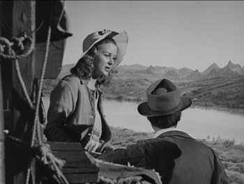 Movie still from “The Grapes of Wrath” (1940), directed by John Ford – An old black and white photo of a woman and a man; Medium shot, Over the shoulder angle