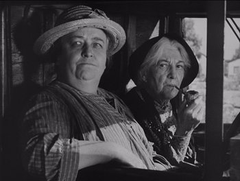 Movie still from “The Grapes of Wrath” (1940), directed by John Ford – Two older women sitting next to each other; Close Up shot, Low angle