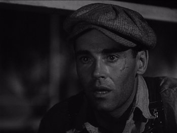 Movie still from “The Grapes of Wrath” (1940), directed by John Ford – A man wearing a hat and looking at the camera; Close Up shot, Low angle