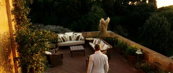 Movie still from “The Great Beauty” (2013), directed by Paolo Sorrentino – A man in a white suit standing on a patio; Extreme Wide shot, High angle
