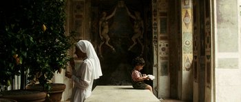 Movie still from “The Great Beauty” (2013), directed by Paolo Sorrentino – A woman and a child sitting in front of a painting; Wide shot, Low angle