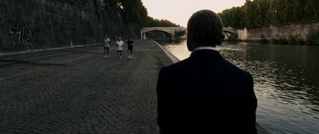 Movie still from “The Great Beauty” (2013), directed by Paolo Sorrentino – A group of people running on a path near a river; Wide shot, Over the shoulder angle