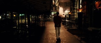Movie still from “The Great Beauty” (2013), directed by Paolo Sorrentino – A man walking down a sidewalk at night; Wide shot, Low angle