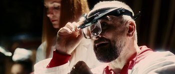 Movie still from “The Great Beauty” (2013), directed by Paolo Sorrentino – A man wearing a pair of glasses looking at the camera; Close Up shot, Over the shoulder angle