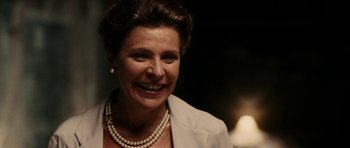 Movie still from “The Great Beauty” (2013), directed by Paolo Sorrentino – A person wearing a suit and pearls; Close Up shot, Over the shoulder angle