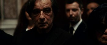 Movie still from “The Great Beauty” (2013), directed by Paolo Sorrentino – A man in a suit and tie standing next to another man in a suit and tie; Close Up shot, Over the shoulder angle