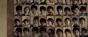 Movie still from “The Great Beauty” (2013), directed by Paolo Sorrentino – A series of photographs of a young boy's faces; Extreme Close Up shot, Overhead angle
