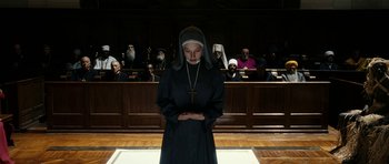 Movie still from “The Great Beauty” (2013), directed by Paolo Sorrentino – A woman standing in front of a group of people in a courtroom; Wide shot, Low angle