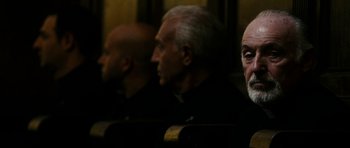 Movie still from “The Great Beauty” (2013), directed by Paolo Sorrentino – A group of men sitting next to each other in a room; Close Up shot, Low angle