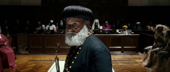 Movie still from “The Great Beauty” (2013), directed by Paolo Sorrentino – An old man with a long beard wearing a hat and holding a staff; Close Up shot, Low angle