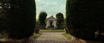 Movie still from “The Great Beauty” (2013), directed by Paolo Sorrentino – A person standing in a garden with a gazebo; Extreme Wide shot, Low angle