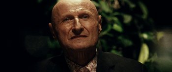 Movie still from “The Great Beauty” (2013), directed by Paolo Sorrentino – An old man with a bald head and a red tie; Close Up shot, Low angle