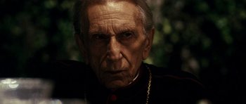 Movie still from “The Great Beauty” (2013), directed by Paolo Sorrentino – An old man with a beard wearing a priest's outfit; Close Up shot, Over the shoulder angle