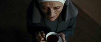 Movie still from “The Great Beauty” (2013), directed by Paolo Sorrentino – An older woman holding a cup of tea; Close Up shot, High angle