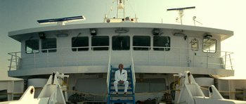 Movie still from “The Great Beauty” (2013), directed by Paolo Sorrentino – A man sitting on a ladder on a boat in the water; Wide shot, Low angle