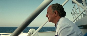 Movie still from “The Great Beauty” (2013), directed by Paolo Sorrentino – A person sitting on a boat in the water; Close Up shot, Over the shoulder angle