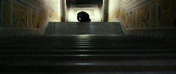 Movie still from “The Great Beauty” (2013), directed by Paolo Sorrentino – A person sitting on the ground in front of some steps; Extreme Wide shot, Low angle