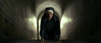 Movie still from “The Great Beauty” (2013), directed by Paolo Sorrentino – An old woman wearing a nun's outfit in front of an archway; Medium shot, Low angle