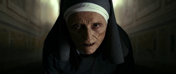Movie still from “The Great Beauty” (2013), directed by Paolo Sorrentino – An old woman wearing a nun's outfit and a cross necklace; Close Up shot, Low angle