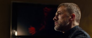 Movie still from “The Green Hornet” (2011), directed by Michel Gondry – A person with a beard looking to the side; Close Up shot, Low angle