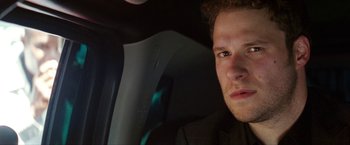 Movie still from “The Green Hornet” (2011), directed by Michel Gondry – A person in a car looking at the camera; Close Up shot, Low angle