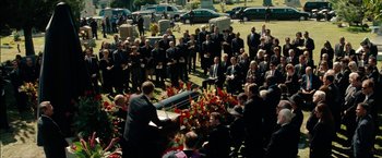Movie still from “The Green Hornet” (2011), directed by Michel Gondry – A crowd of people gathered around a grave; Extreme Wide shot, High angle