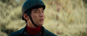 Movie still from “The Green Hornet” (2011), directed by Michel Gondry – A man wearing a helmet while standing in a field; Close Up shot, Low angle