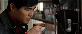 Movie still from “The Green Hornet” (2011), directed by Michel Gondry – A man holding a cup of coffee in his hand; Close Up shot, Over the shoulder angle