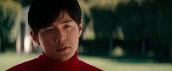 Movie still from “The Green Hornet” (2011), directed by Michel Gondry – A person wearing a red sweater; Close Up shot, Over the shoulder angle