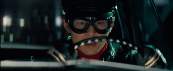 Movie still from “The Green Hornet” (2011), directed by Michel Gondry – A man in a helmet and goggles driving a car; Close Up shot, Low angle
