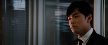 Movie still from “The Green Hornet” (2011), directed by Michel Gondry – A person with short black hair is looking at the camera; Close Up shot, Low angle