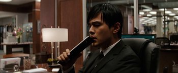 Movie still from “The Green Hornet” (2011), directed by Michel Gondry – A man in a suit and tie holding an electric toothbrush in his mouth; Close Up shot, Over the shoulder angle