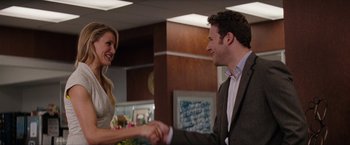 Movie still from “The Green Hornet” (2011), directed by Michel Gondry – A man and a woman shaking hands in a room; Medium shot, Over the shoulder angle