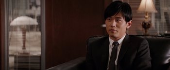 Movie still from “The Green Hornet” (2011), directed by Michel Gondry – A man wearing a suit and tie sitting in a chair; Close Up shot, Over the shoulder angle