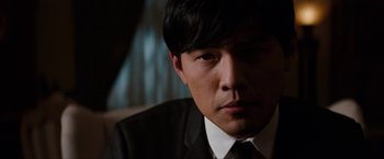 Movie still from “The Green Hornet” (2011), directed by Michel Gondry – A person wearing a suit and tie; Close Up shot, Over the shoulder angle