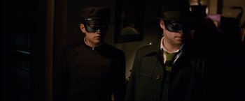 Movie still from “The Green Hornet” (2011), directed by Michel Gondry – Two men in military garb and black hats; Medium shot, Low angle