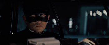 Movie still from “The Green Hornet” (2011), directed by Michel Gondry – A man wearing a mask sitting in the back of a car; Close Up shot, Low angle