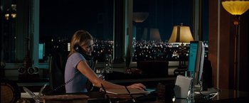 Movie still from “The Green Hornet” (2011), directed by Michel Gondry – A woman sitting in front of a computer at night; Medium shot, Over the shoulder angle
