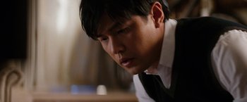 Movie still from “The Green Hornet” (2011), directed by Michel Gondry – A person wearing a suit and tie; Close Up shot, Low angle