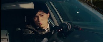 Movie still from “The Green Hornet” (2011), directed by Michel Gondry – A man in a leather jacket driving in a car; Close Up shot, Low angle