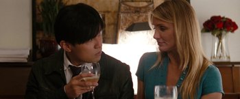 Movie still from “The Green Hornet” (2011), directed by Michel Gondry – A man and a woman sitting at a table with a glass of wine; Close Up shot, Over the shoulder angle