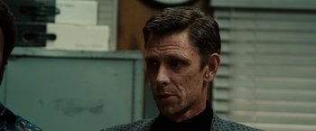 Movie still from “The Green Hornet” (2011), directed by Michel Gondry – A person wearing a suit and tie; Close Up shot, Over the shoulder angle