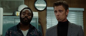 Movie still from “The Green Hornet” (2011), directed by Michel Gondry – Two men standing next to each other in front of a clock; Close Up shot, Low angle