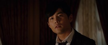 Movie still from “The Green Hornet” (2011), directed by Michel Gondry – A man in a suit and tie looking to his left; Close Up shot, Over the shoulder angle