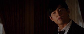 Movie still from “The Green Hornet” (2011), directed by Michel Gondry – A young asian man looking at the camera; Close Up shot, Over the shoulder angle